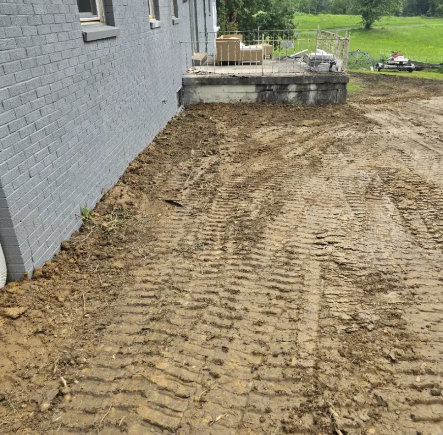 Graded dirt running along the side of a house